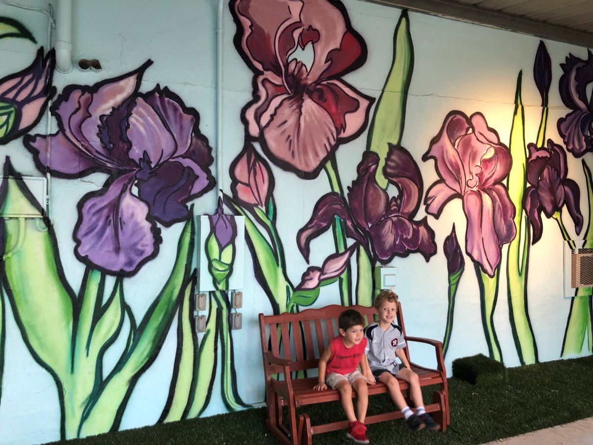 Kinds in front of a mural