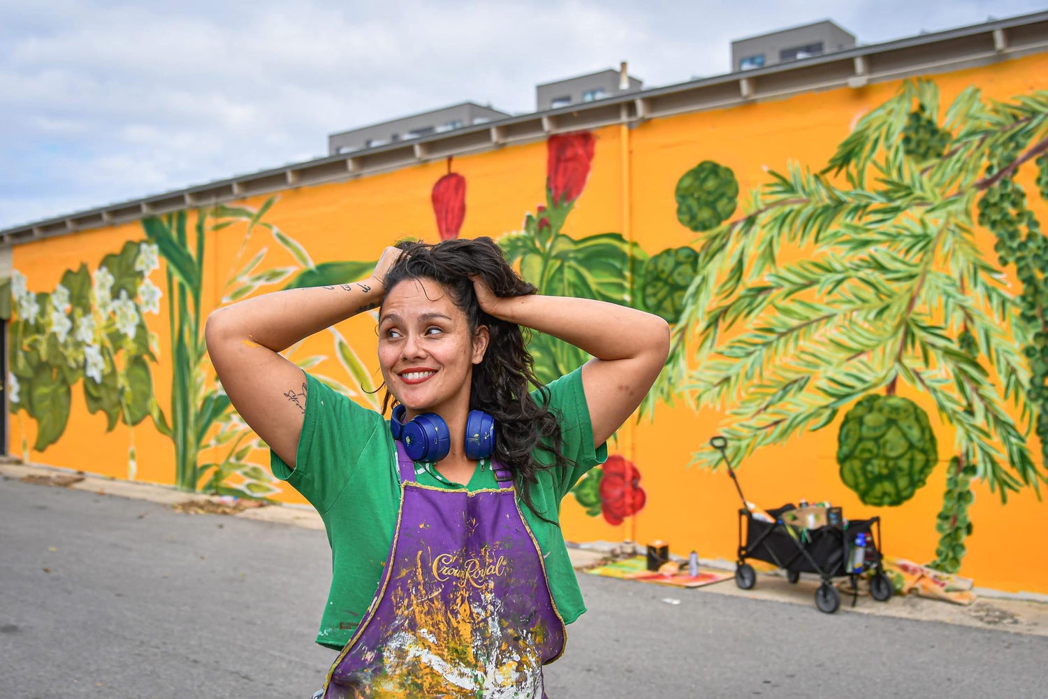 Woman standing in front of a mural