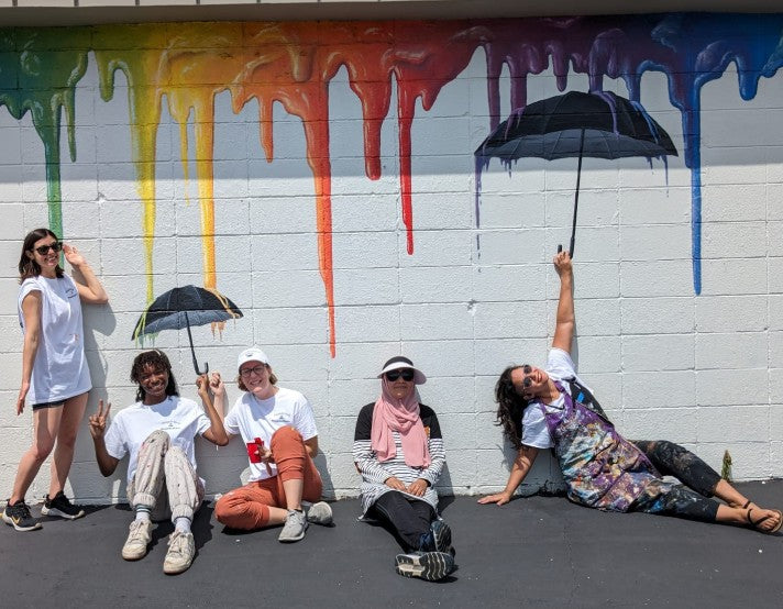 Women in front of a mural